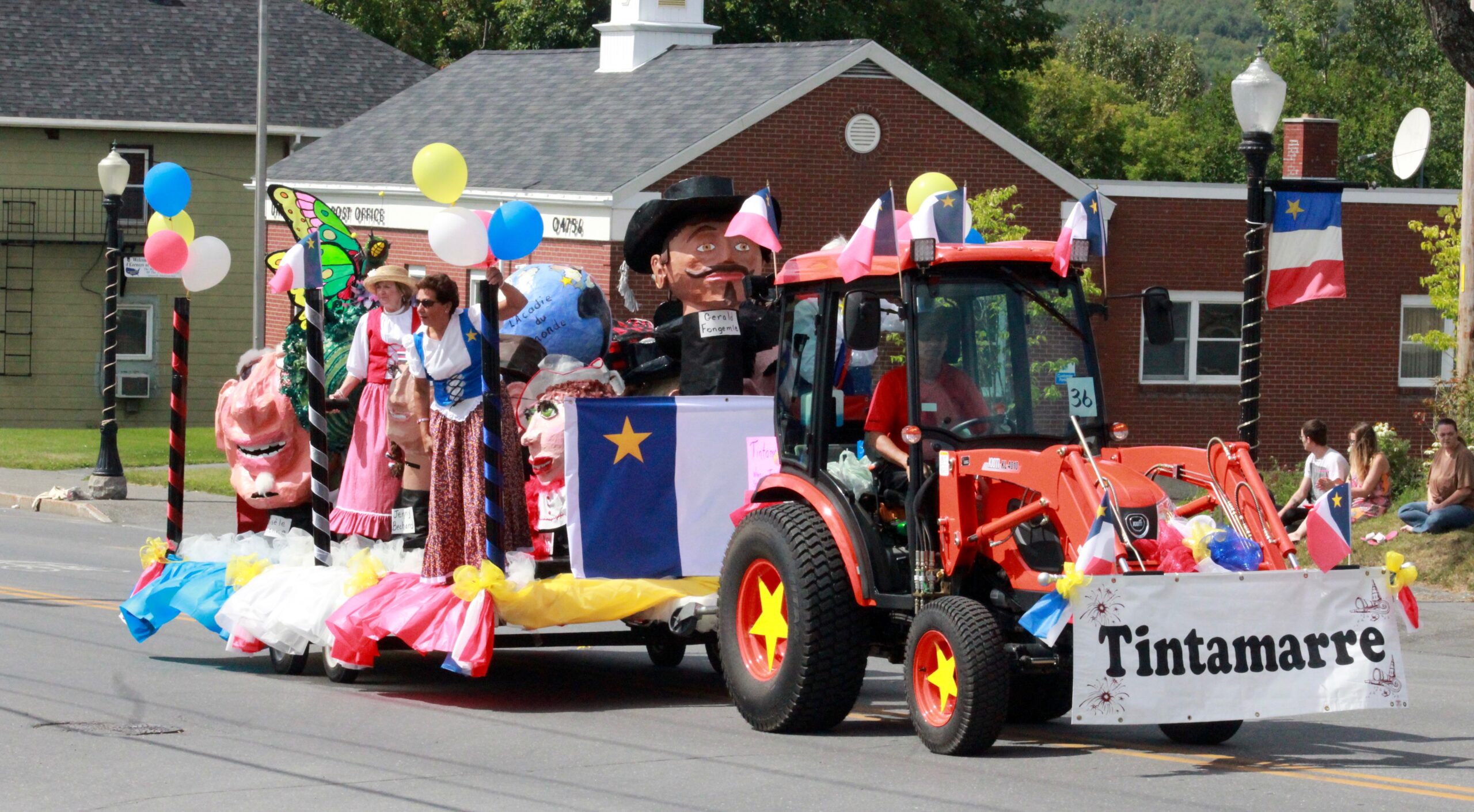 A float drives down Main Street in Madawaska during the Acadian Festival Parade on Sunday, Aug. 13. The float advertised the traditional tintamarre, where folks march through streets making fanfare with improvised instruments and noisemakers, which was to be held on Tuesday, Aug. 15, during National Acadian Day. (Courtesy of Elizabeth Theriault)