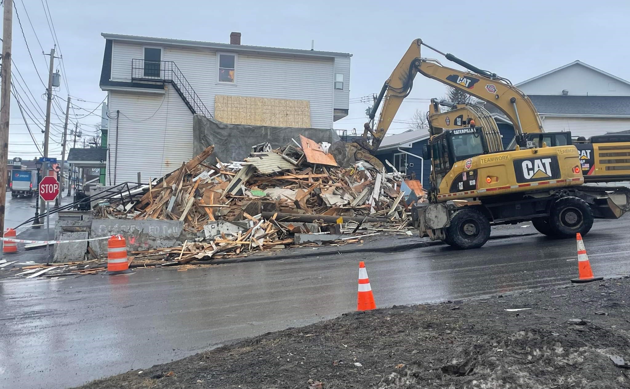 A residential building on the corner of 14th Avenue and Main Street in Madawaska is being demolished by Ed Pelletier & Sons as part of the Midtown Plaza Demolition deal on Apr. 26. (Emily Jerkins | St. John Valley Times)