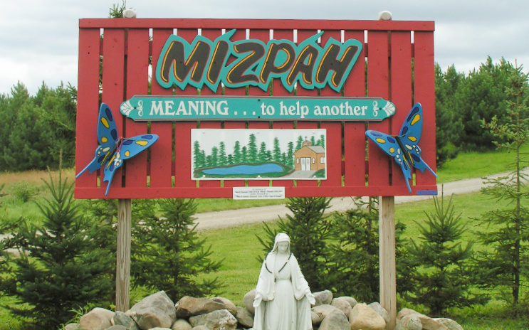 Mizpah's welcome sign greets visitors to the Grand Isle site.